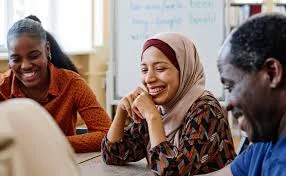 Group of adults smiling together during a community discussion