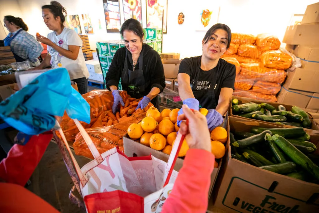 Volunteers sorting fresh produce for a food distribution program